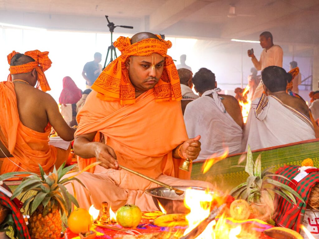 A vibrant Hindu ceremony with monks performing rituals in Dhaka, Bangladesh.