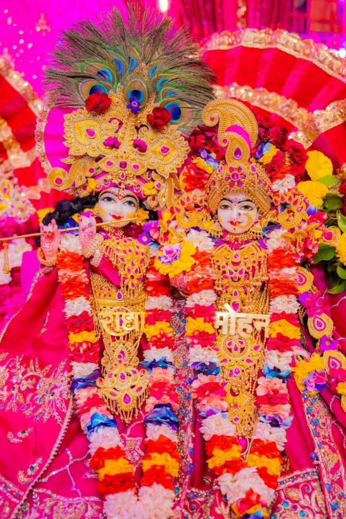 Vibrant depiction of Hindu deities adorned in traditional attire with intricate floral garlands.