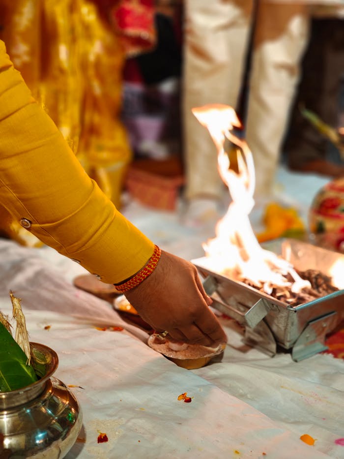 A close-up of a sacred fire ritual during a traditional Indian wedding ceremony in Prayagraj, India.